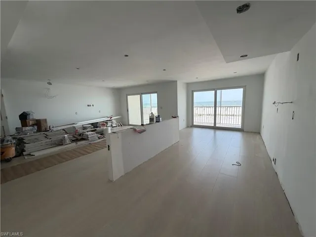 Living/Kitchen space. features 2 sets of slider doors accessing beachfront balcony. construction progress