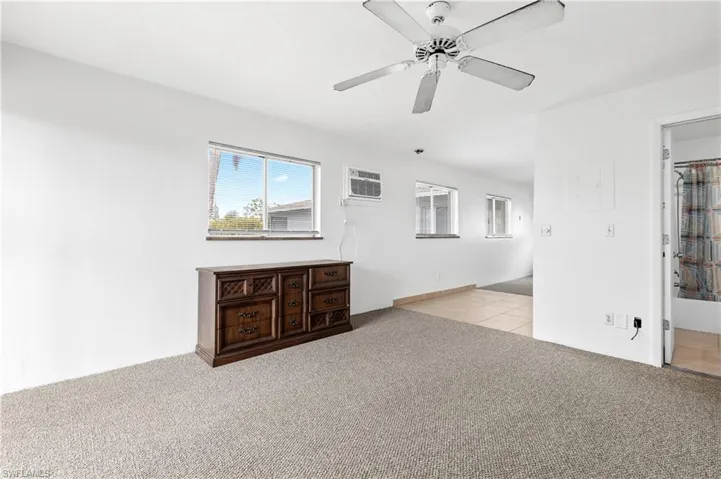 Spare room with light carpet and a ceiling fan