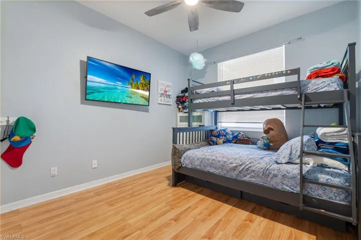 Bedroom with light wood-style floors and a ceiling fan