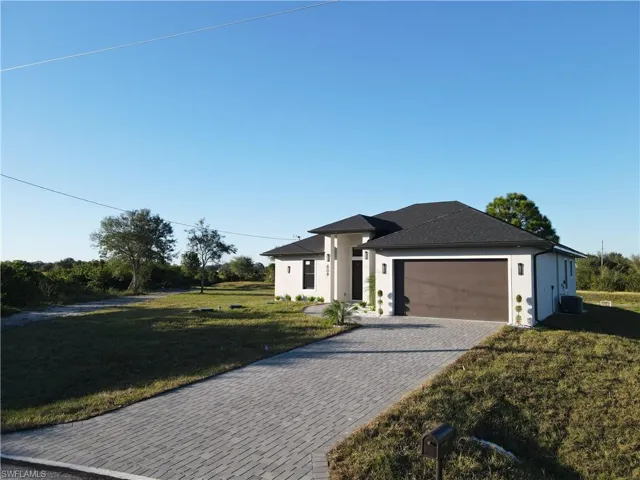 View of front of home featuring a garage and a front yard