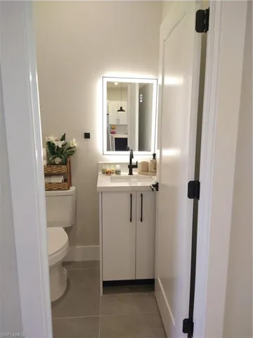 Bathroom with tile patterned floors, vanity, and toilet