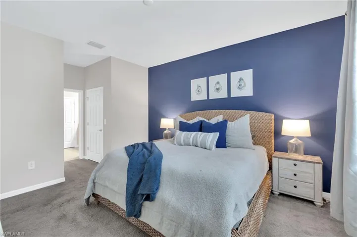 Carpeted bedroom featuring baseboards