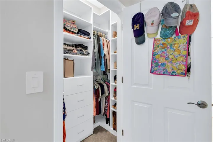 Walk in closet featuring carpet