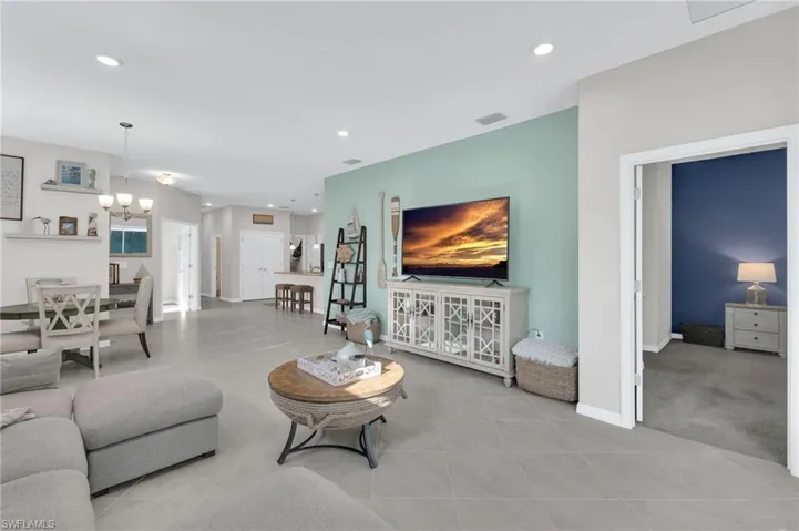 Living area featuring a chandelier, recessed lighting, and tile patterned flooring