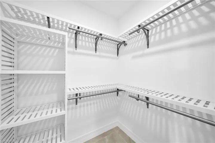 Walk in closet featuring tile flooring