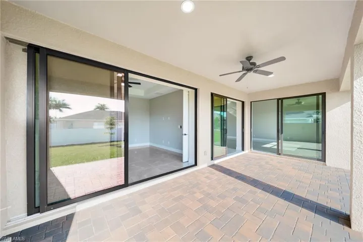 Unfurnished sunroom with a healthy amount of sunlight and ceiling fan