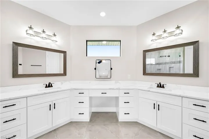 Bathroom with tile flooring, double sink, and large vanity