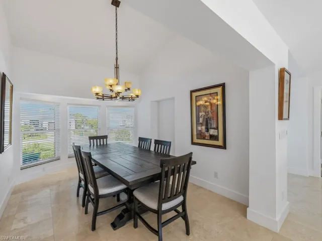 Dining room with a chandelier and high vaulted ceiling