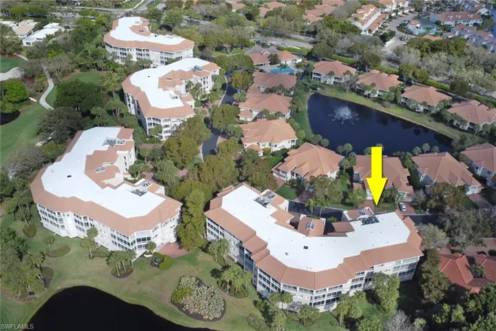 Aerial view of property and surrounding area featuring a nearby body of water and apartment complex / building