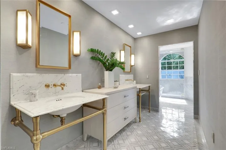Full bath featuring a tub and tile walls