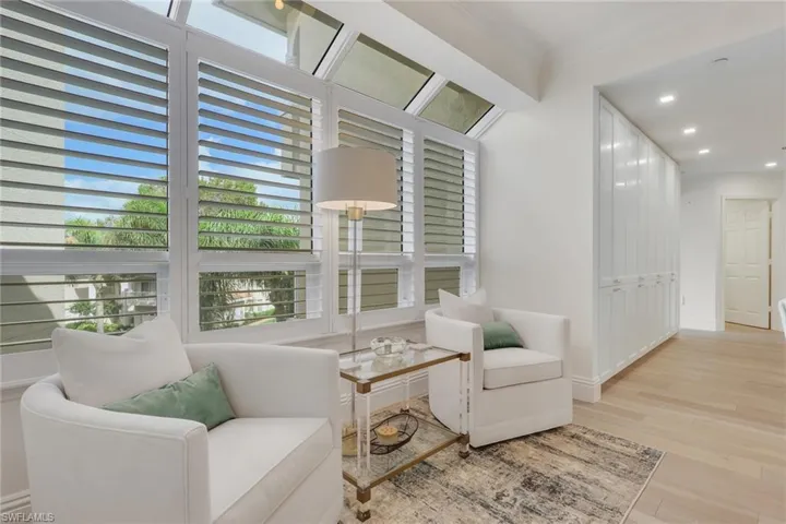 Sitting room with real wood floors, recessed lighting, and crown molding