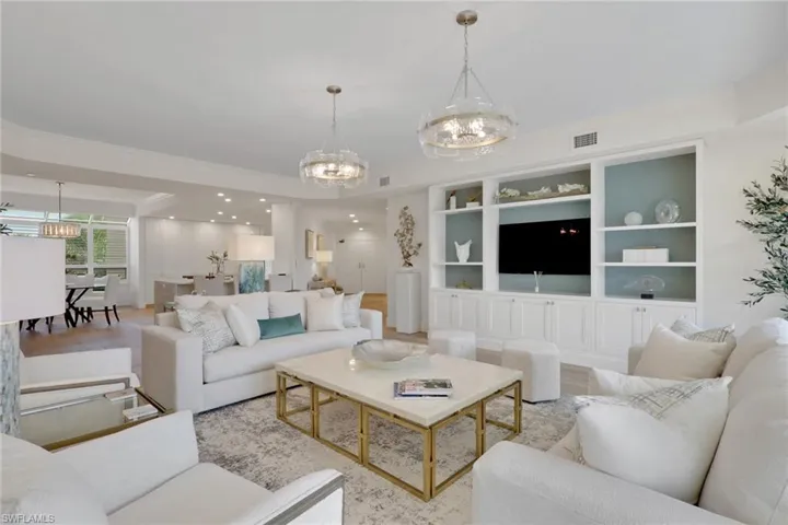 Living area featuring hanging lights and real wood floors