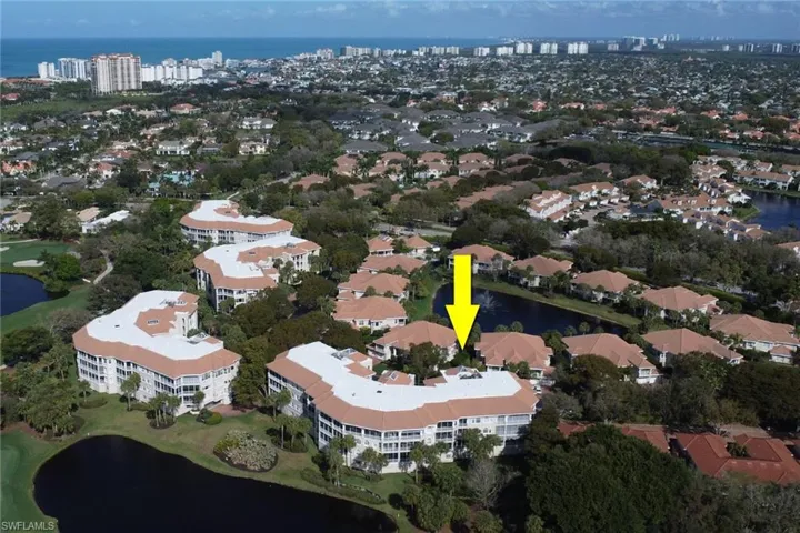 Aerial view of property and surrounding area featuring a nearby body of water and nearby urban area