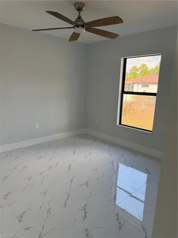 Full bath featuring vanity, shower / bath combination, and light marble finish flooring