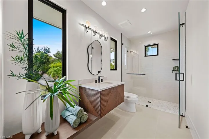 Bathroom with a stall shower, vanity, recessed lighting, and tile patterned floors