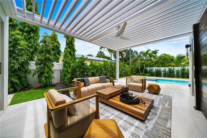 Fenced backyard with an outdoor living space, a ceiling fan, a pergola, and a patio area