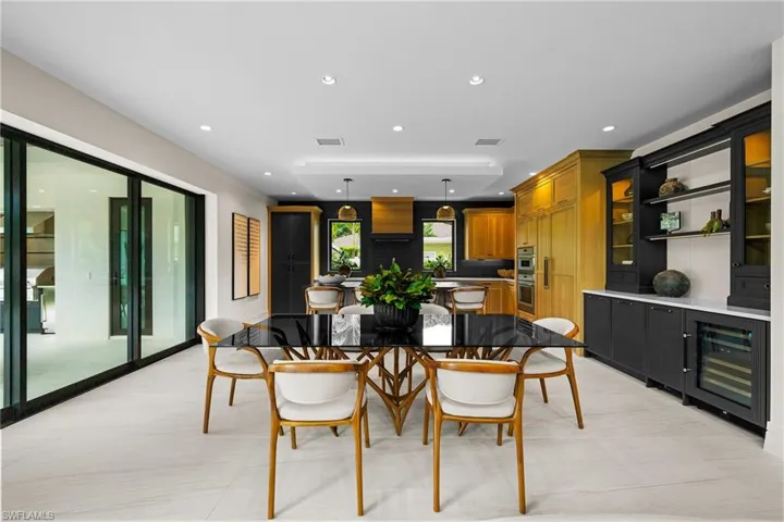 Dining space featuring beverage cooler, recessed lighting, and light tile patterned flooring