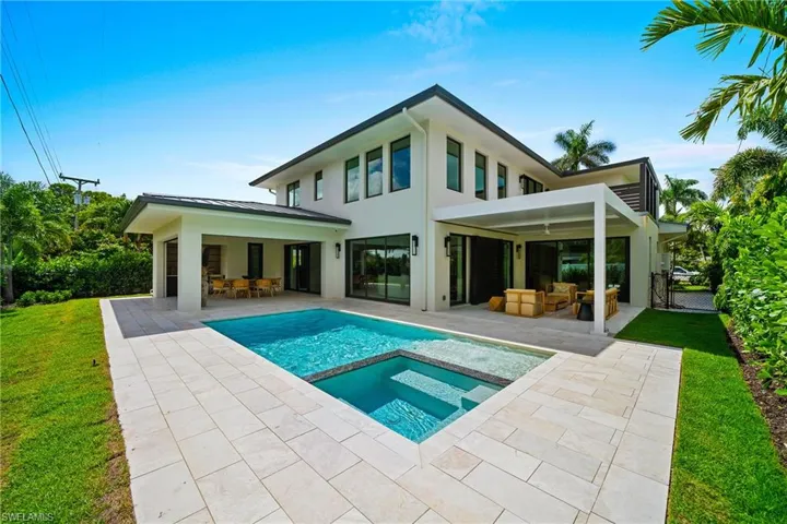 Rear view of house featuring a patio, stucco siding, outdoor lounge area, and a yard