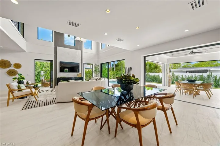 Dining space featuring recessed lighting, a ceiling fan, and a high ceiling