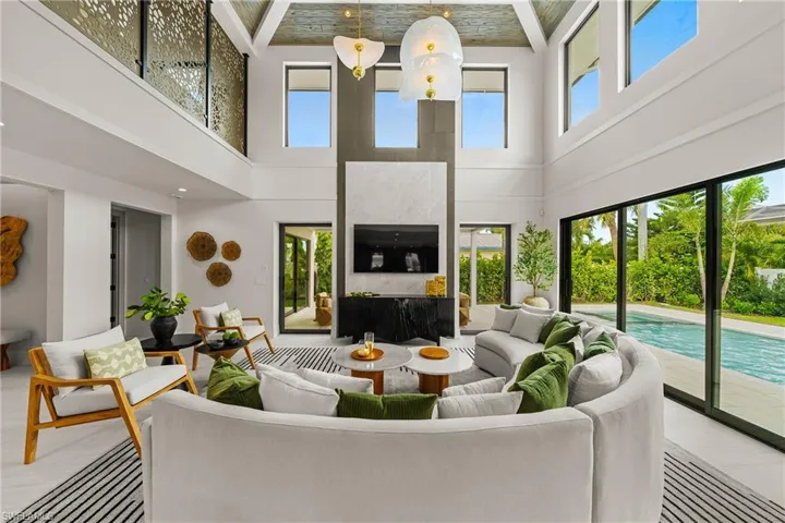 Living area featuring a towering ceiling and a fireplace
