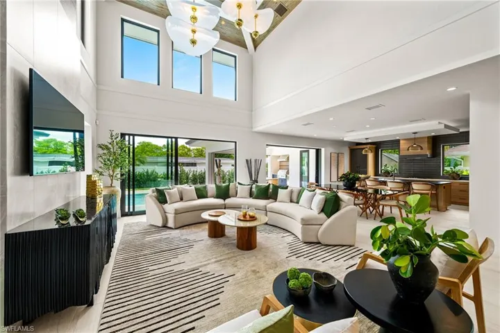 Living area with a towering ceiling and recessed lighting