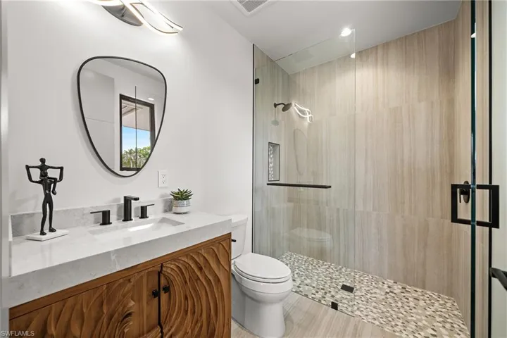 Full bathroom featuring vanity and tiled shower