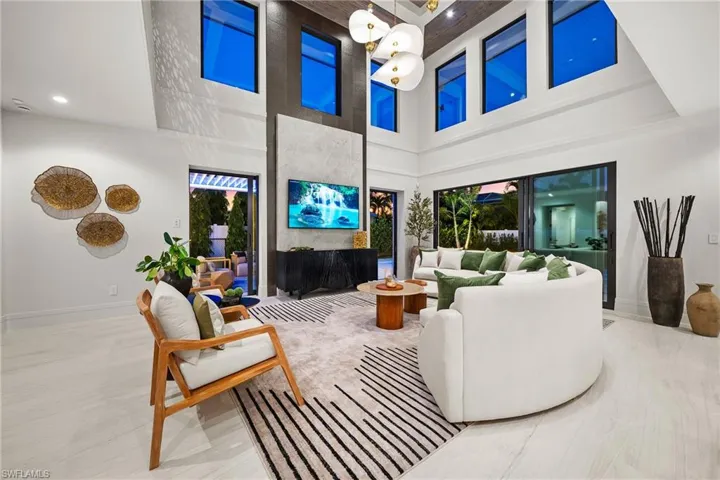 Living room with a towering ceiling and recessed lighting
