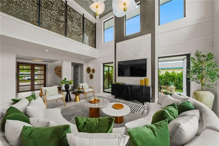 Living area featuring plenty of natural light and a high ceiling