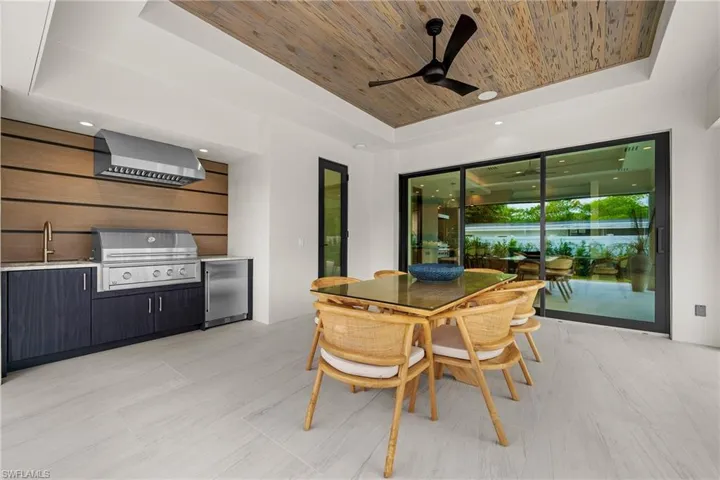 Dining area featuring a raised ceiling, wooden ceiling, and ceiling fan