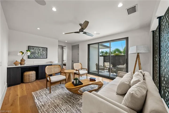Living room with recessed lighting, light wood-style flooring, and a ceiling fan