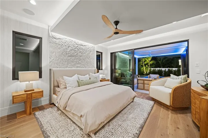 Bedroom with light wood-style floors and a ceiling fan