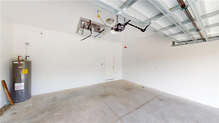 Garage with water heater and a garage door opener