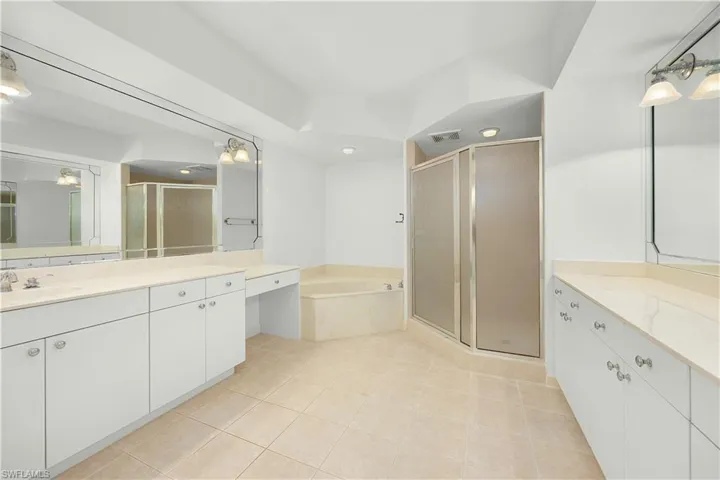 Full bathroom with a garden tub, a stall shower, vanity, and light tile patterned flooring
