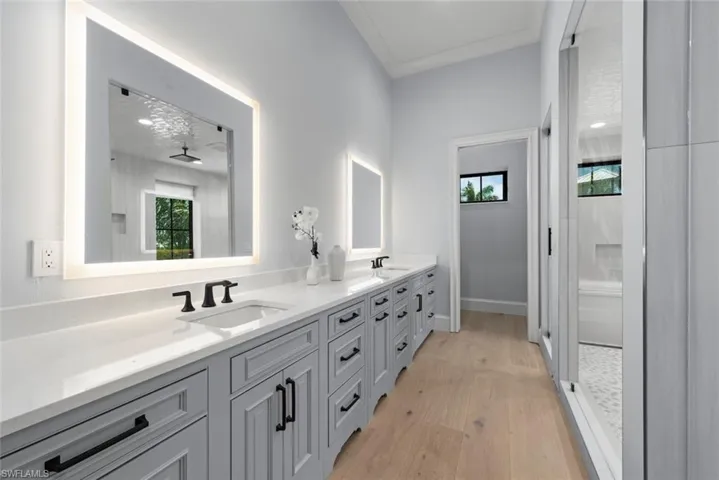 WoodMode cabinetry, double sinks, lighted mirrors