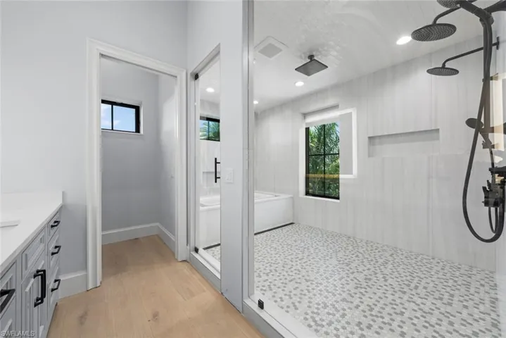 Wet Room with multiple shower heads and soaking tub