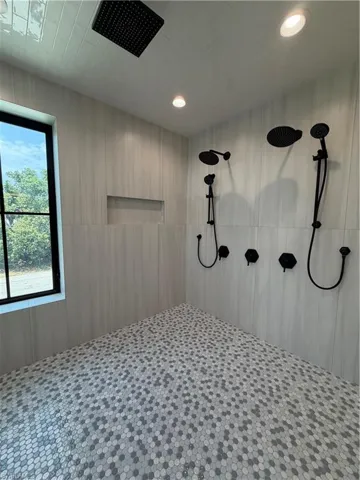 Large wet room with multiple shower heads