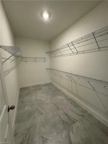 Spacious closet with marble finish flooring