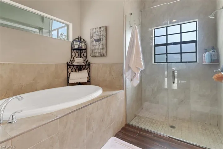 Full bath with a bath and a stall shower