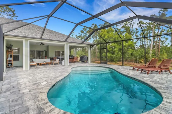 Outdoor pool featuring a grill, a ceiling fan, a patio, and an outdoor hangout area