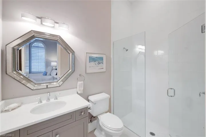 Full bath featuring a stall shower, vanity, and ensuite bath