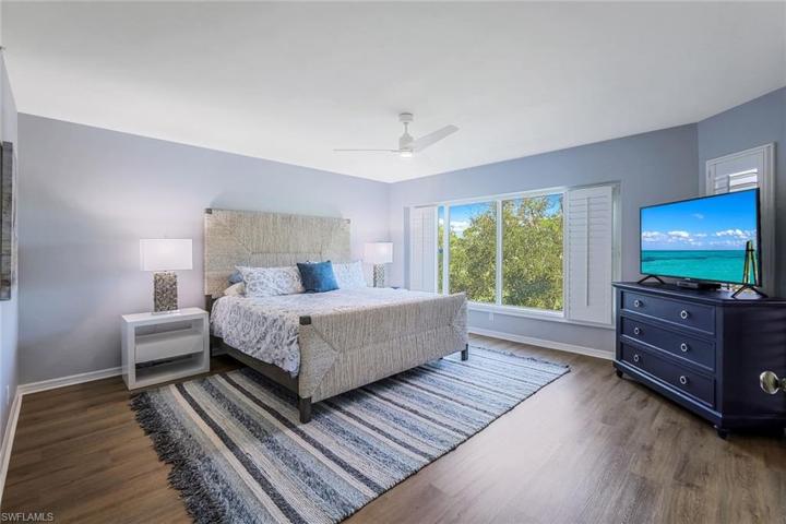 Large primary bedroom suite with expansive golf course view.