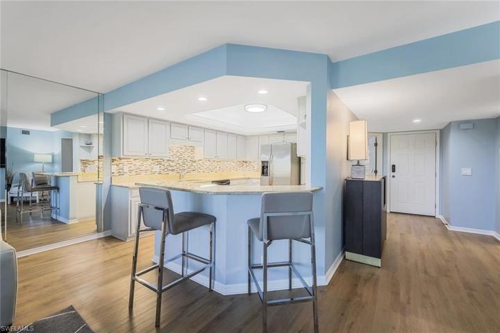 The location of the kitchen allows for conversation with guests while preparing meals.