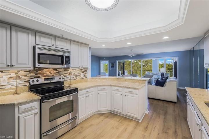 Granite countertops, decorative backsplash and stainless steel appliances.