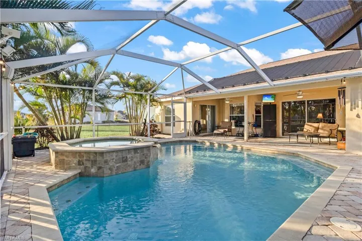 Screened-in lanai, perfect for entertaining, enjoying morning coffee, or unwinding after a day in the sun.