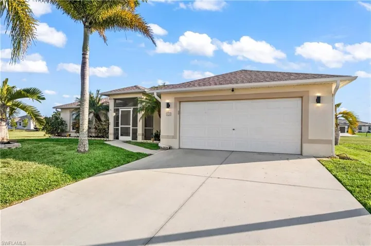 Extended-width driveway leading to a 2-car garage, perfect for multiple vehicles, guests, and additional outdoor space.