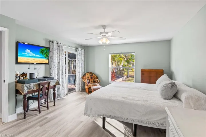 Serene primary suite offering generous space, poolside views, and direct lanai access for true indoor/outdoor Florida living.
