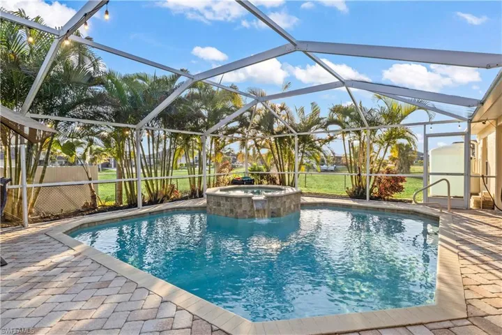 Beautiful solar and electric-heated pool with attached spa, creating a private oasis for relaxation, fun, and outdoor entertaining.