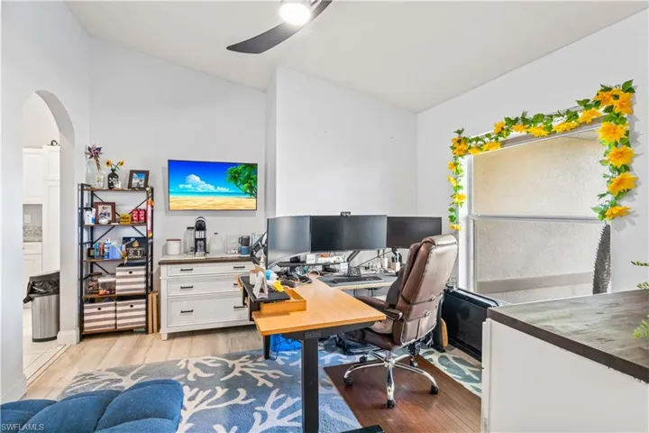 Versatile space currently set up as a home office, featuring a large picture window that fills the room with natural light and offers serene views of the front yard. Perfect for a dedicated workspace, formal dining area, or flexible multi-use room.