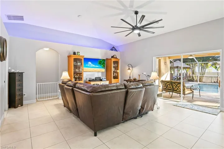 Great room looks out over the tropical pool area.