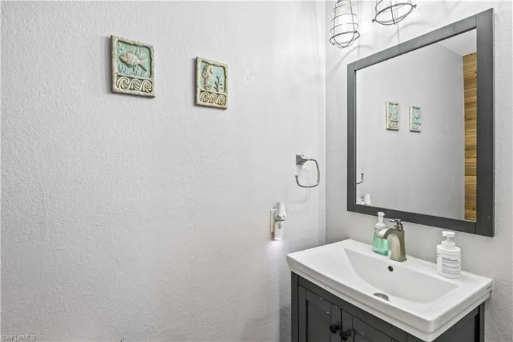 Charming guest half bathroom easily accessible from the great room.